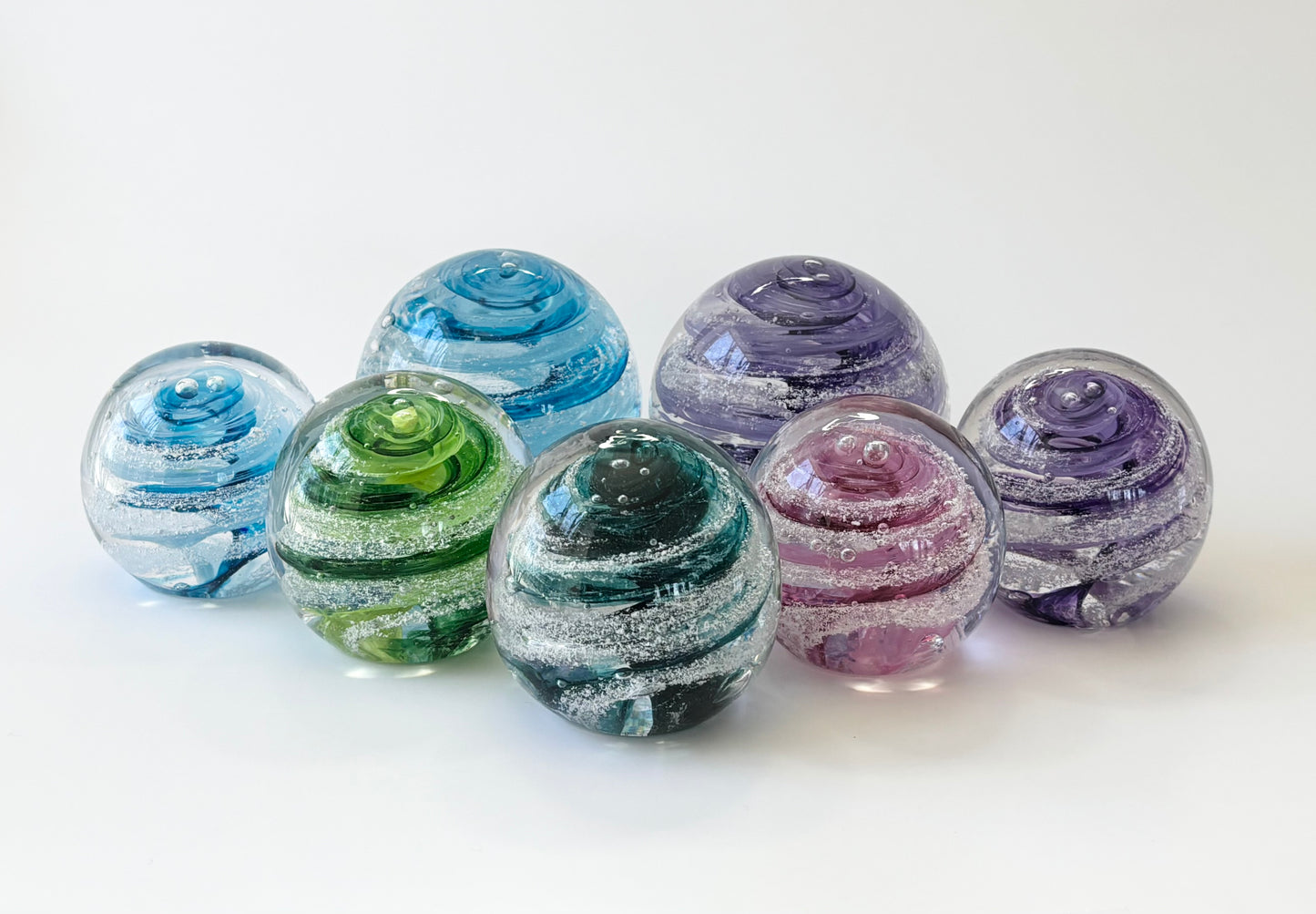 Mini handblown glass memorial orb with your choice of color swirl and cremation ash infusion