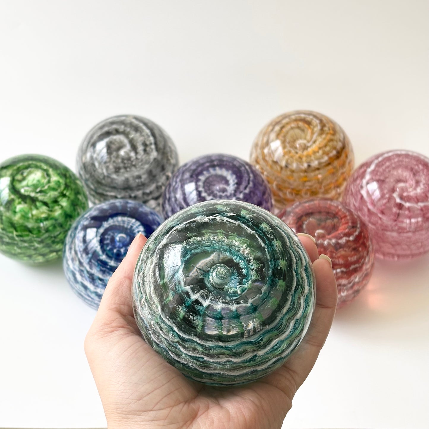 Rippled Vortex glass orb with pet or human cremains suspended in color-rich molten glass
