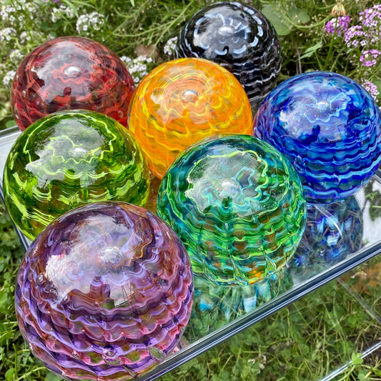 Rippled Vortex series of hand crafted glass memorials infused with cremated remains. Custom made with  your choice of colors. For pets and people