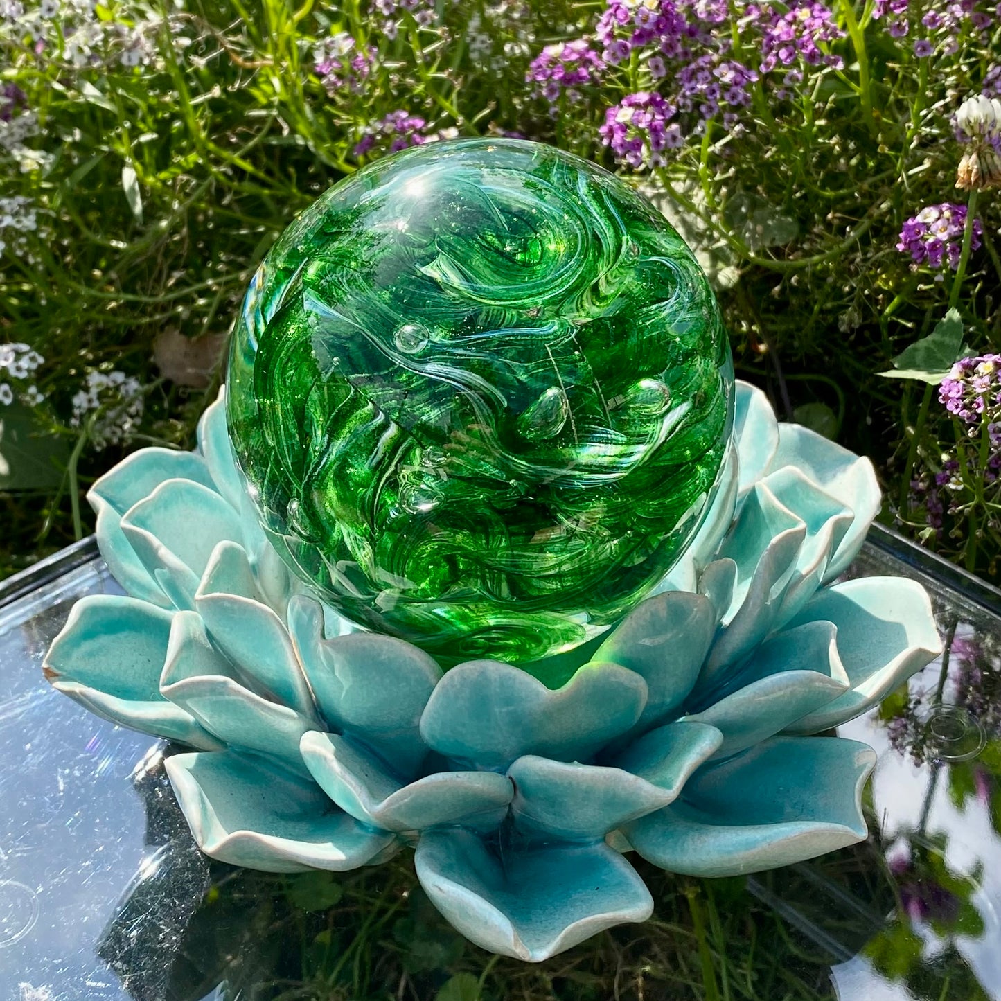Detailed view of green sparkle cremation glass with swirling ashes and shimmering effect in the ribbon twist collection
