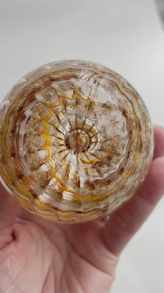 Ash infused remembrance orb in rippled vortex style with gold tones