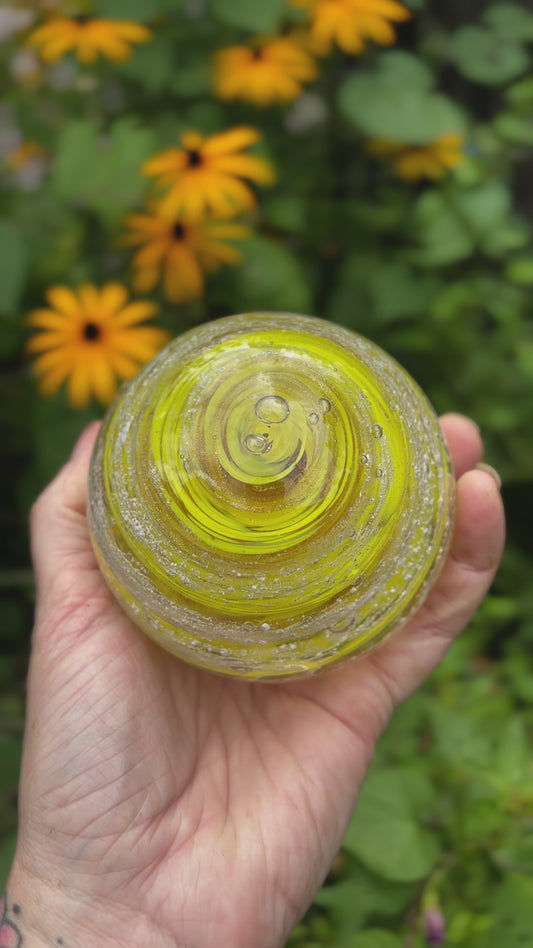 Glass orb infused with ashes and custom pet-inspired color blending gold and yellow