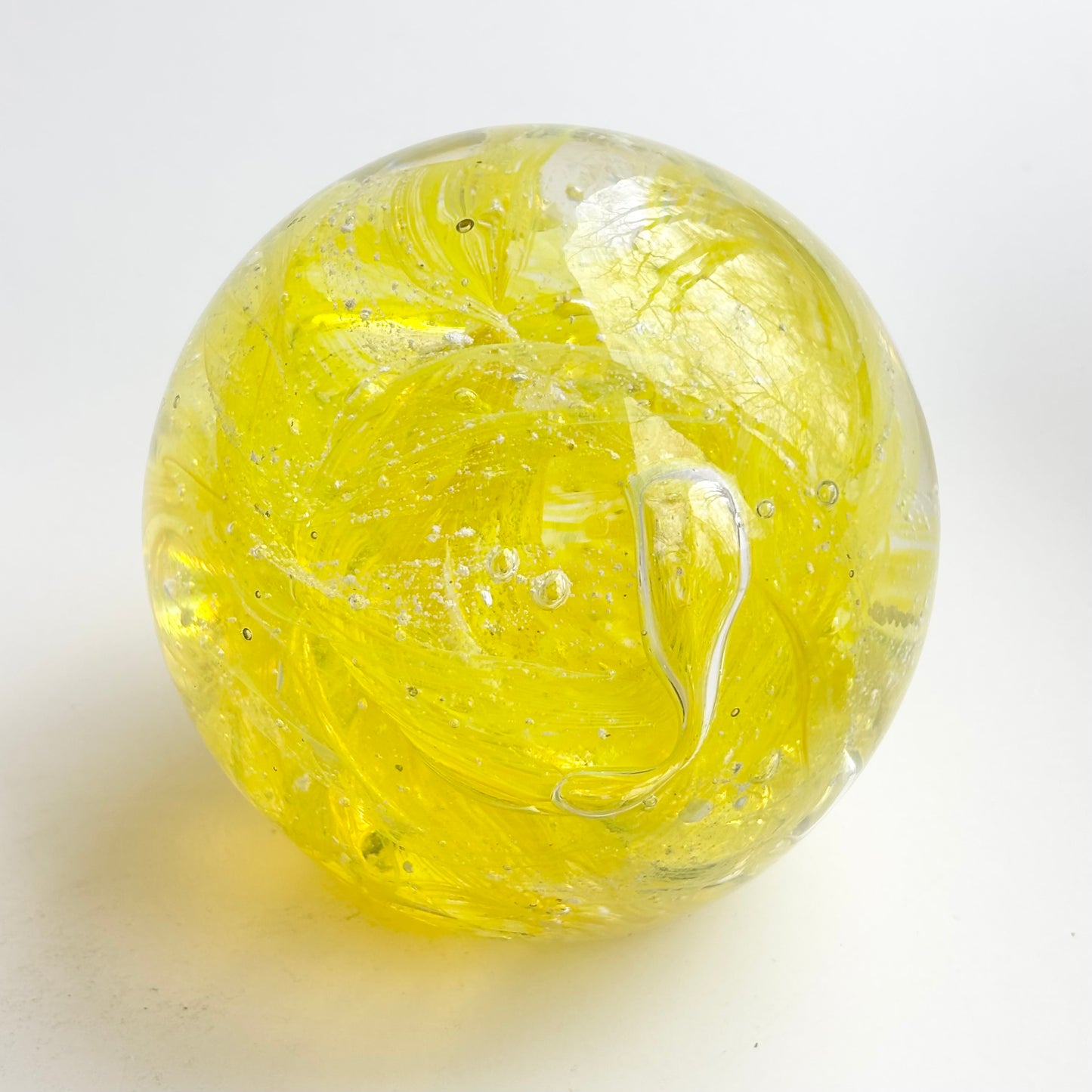 bright sunny yellow cremation memorial orb with ribboned or marbled design pattern