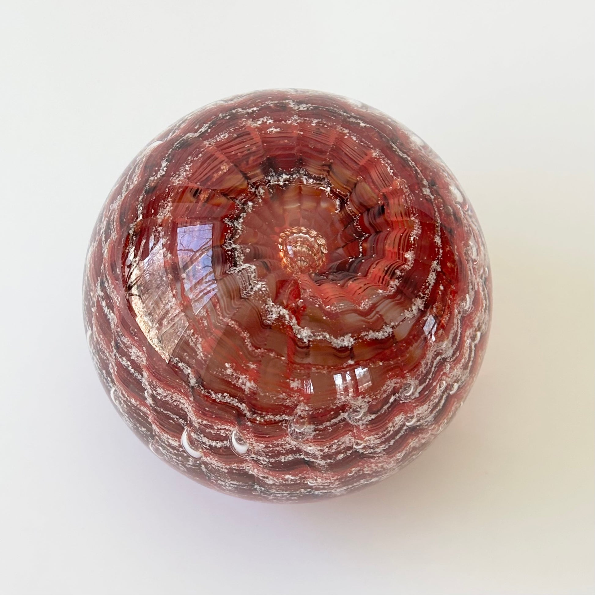 Custom memorial paperweight with visible ashes and three-color ripple swirl design