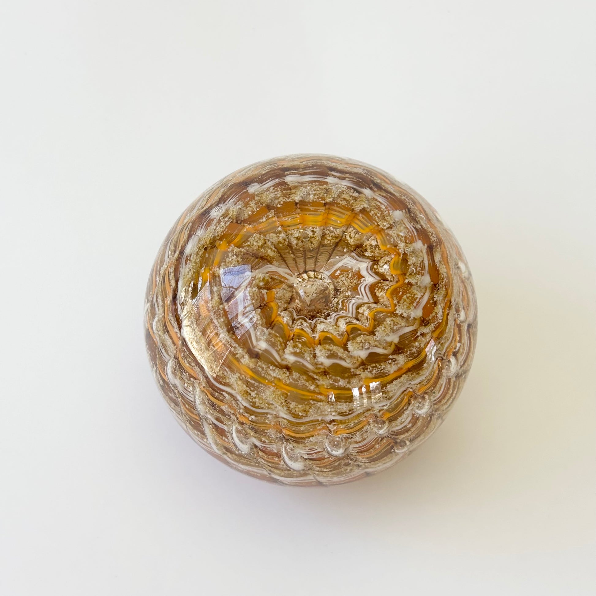Handcrafted glass paperweight with ashes suspended in a calming ripple swirl of custom colors

