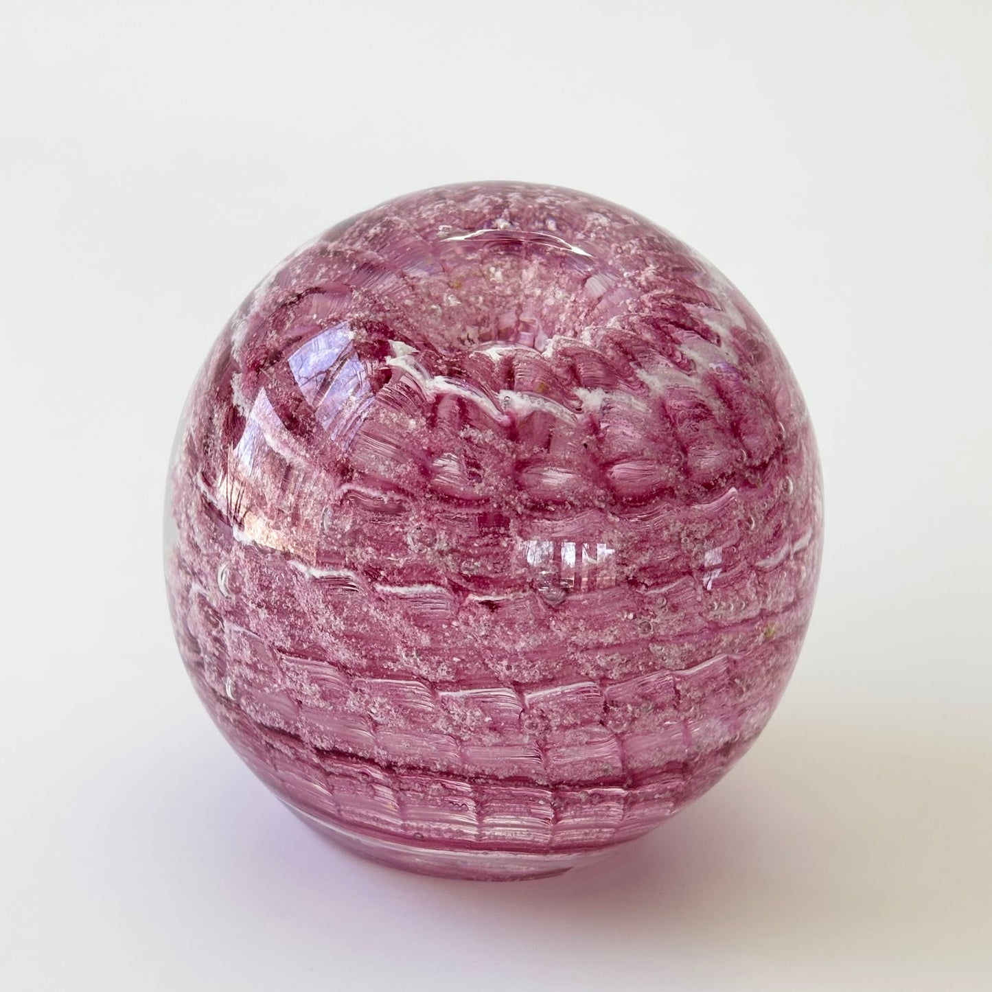 Ripple memorial orb made with ashes, combining light-catching optic texture and soft swirl tones

