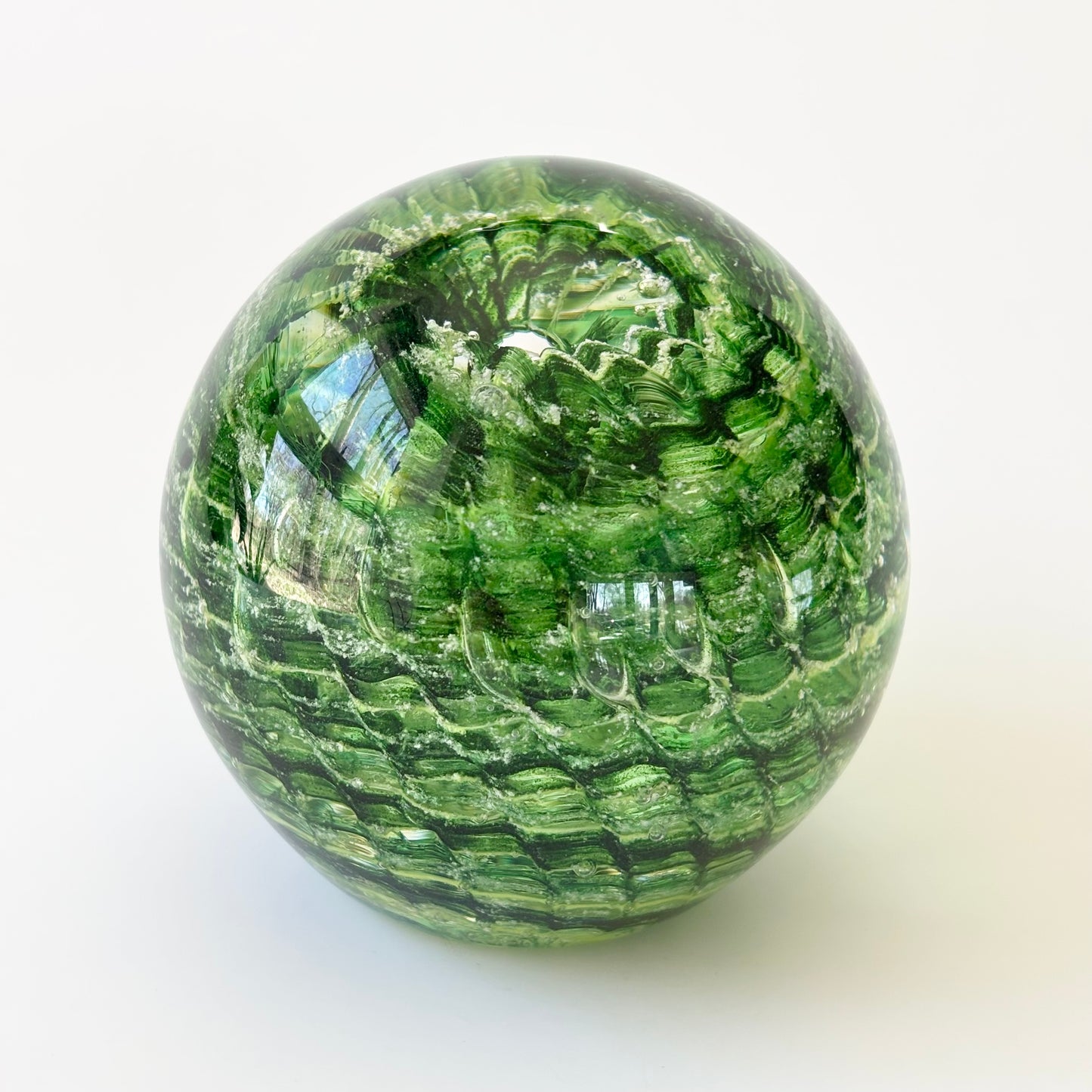 Custom ash-infused glass keepsake with optic ridges and central vortex in handcrafted form