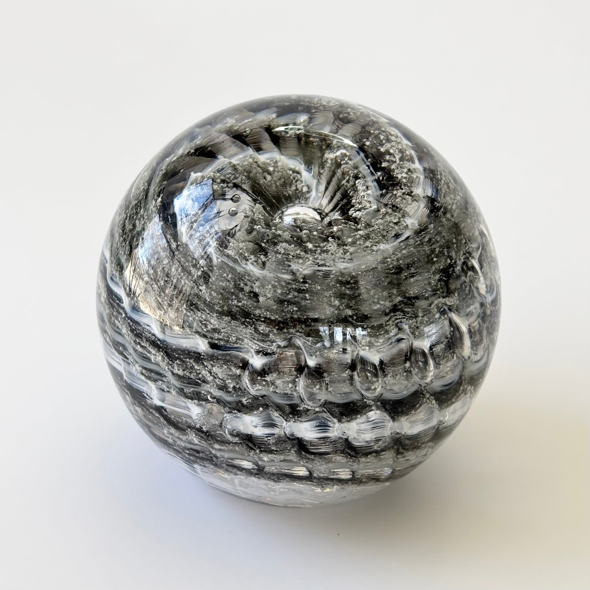 Handblown glass memorial orb with grey rippled swirl and cremation ash infusion

