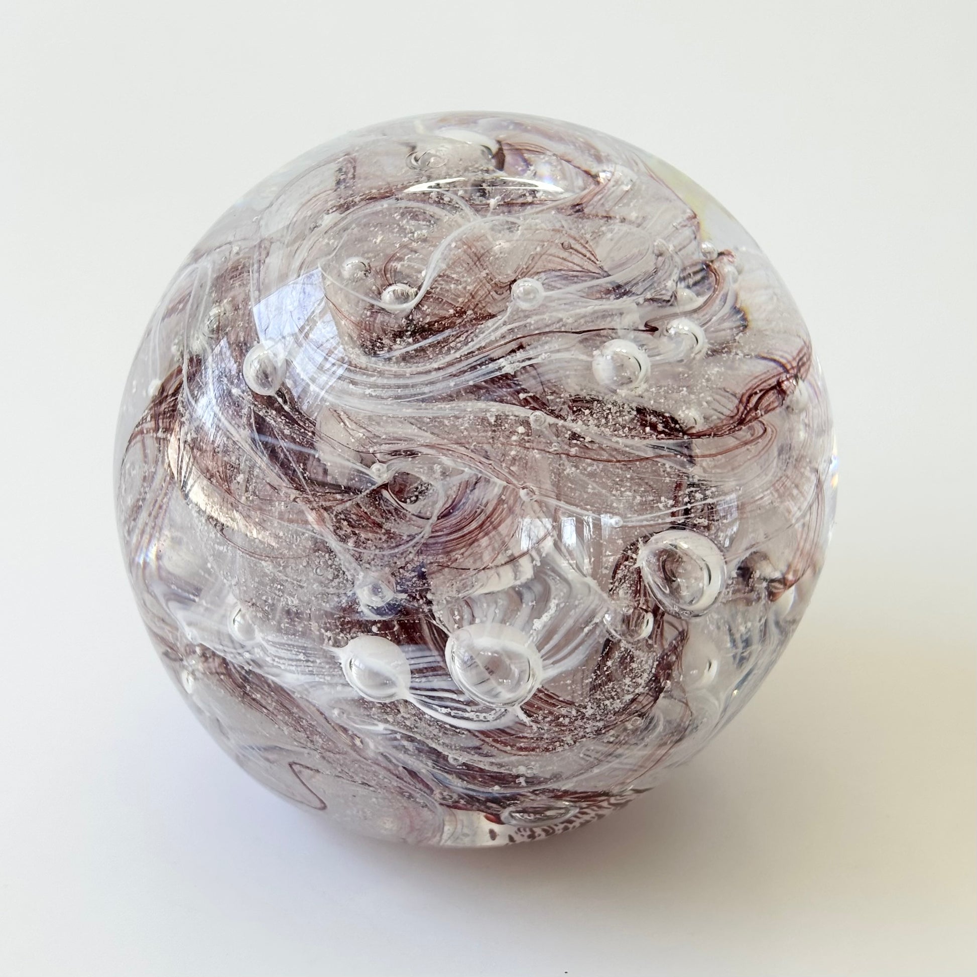 dark red and white cremation memorial orb with ribboned or marbled design pattern