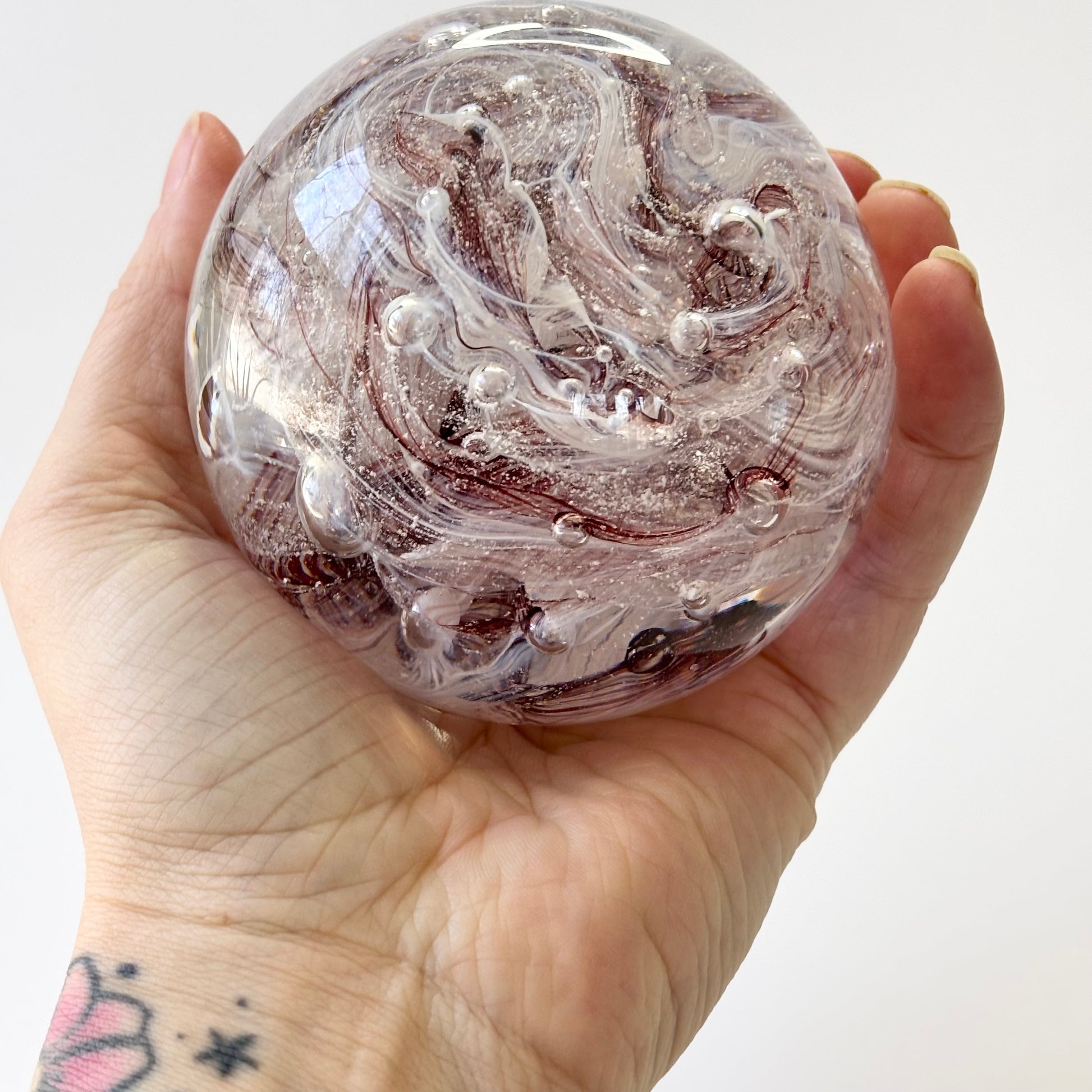 dark red and white cremation memorial orb with ribboned or marbled design pattern