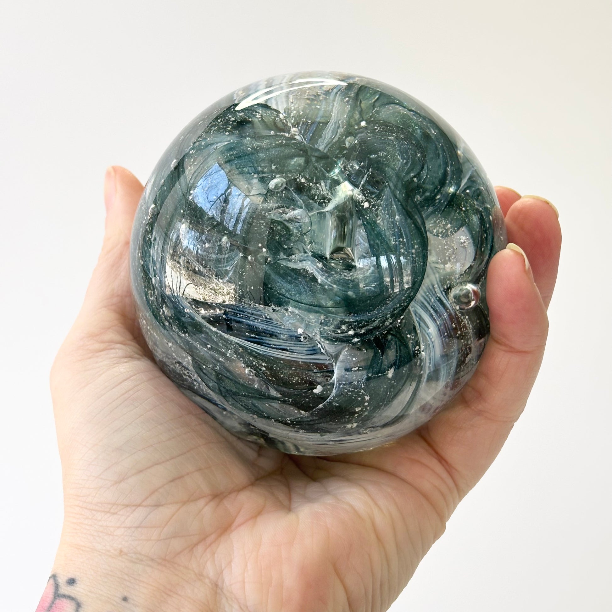 Handcrafted orb with green sparkle swirl and vibrant palette

