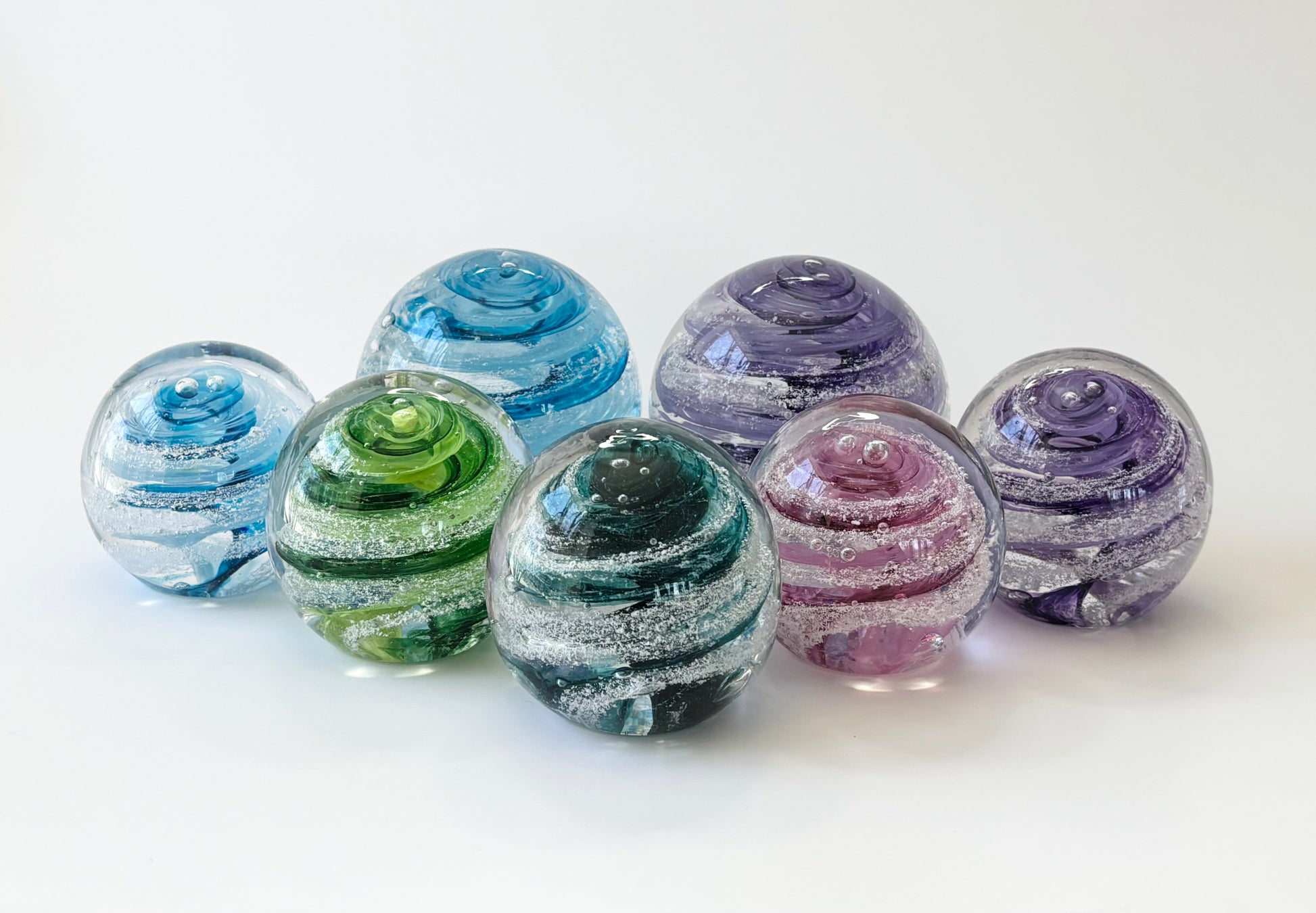 Mini handblown glass memorial orb with your choice of color swirl and cremation ash infusion