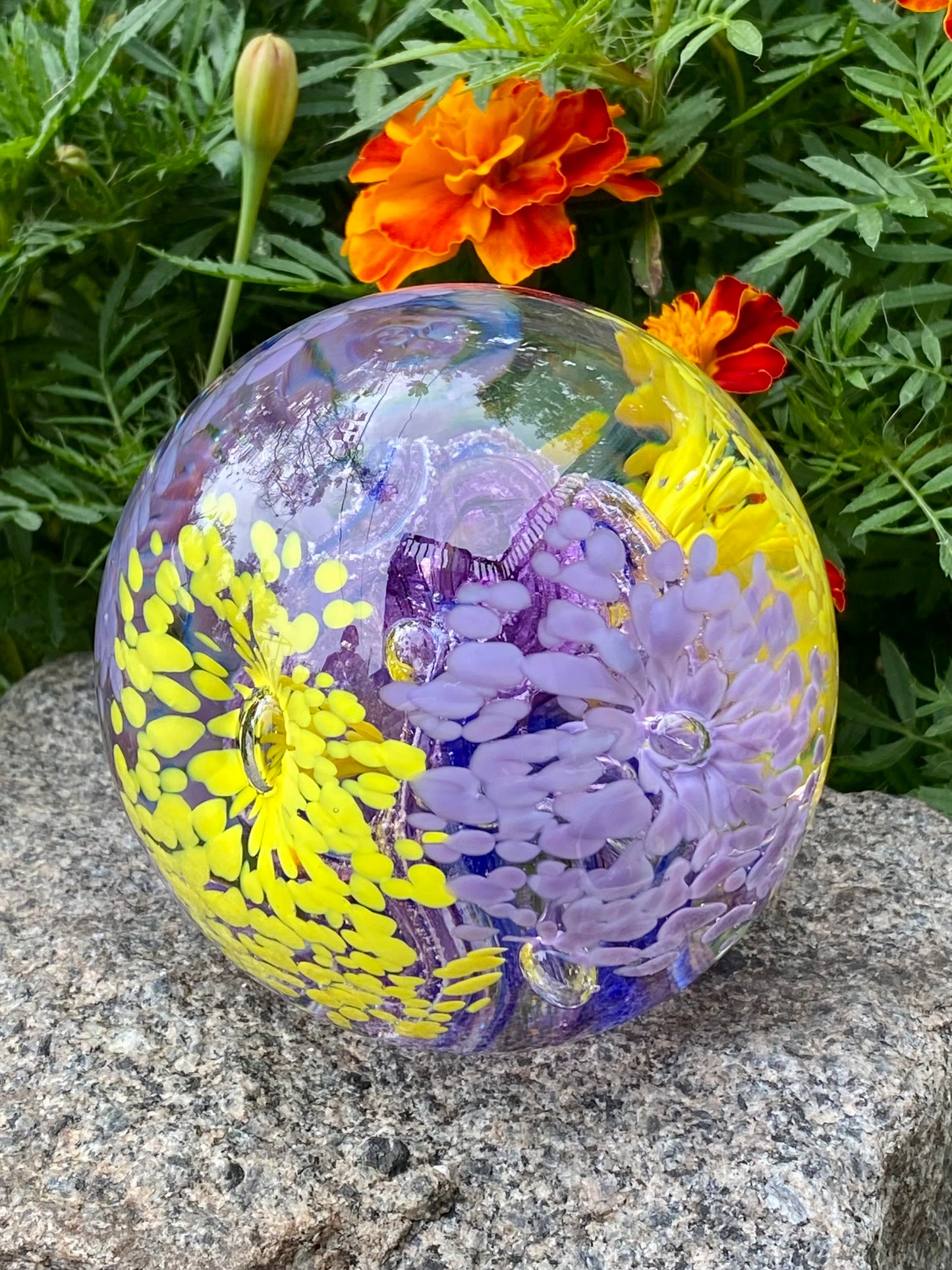 Ash infused glass art with vibrant floral motifs and swirling depth