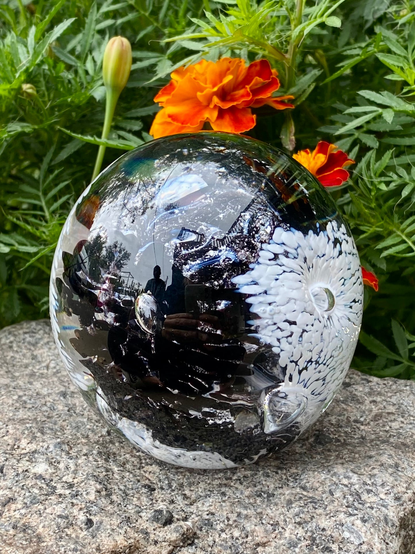Ash infused glass art with vibrant floral motifs and swirling depth in black and white, cremains are swirled into the core