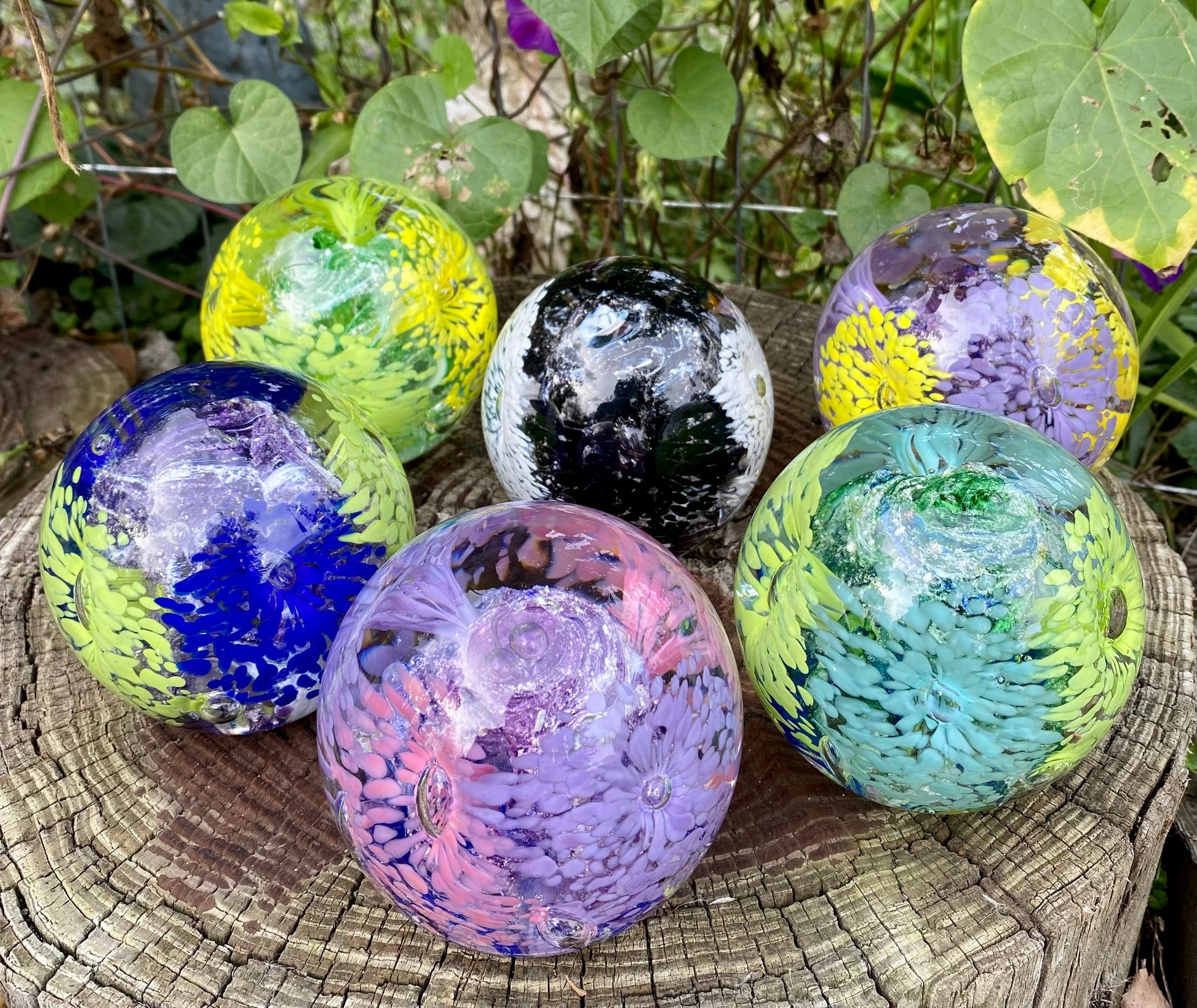 Some color examples of Handblown glass memorial orb with swirled cremation ashes and layered floral design