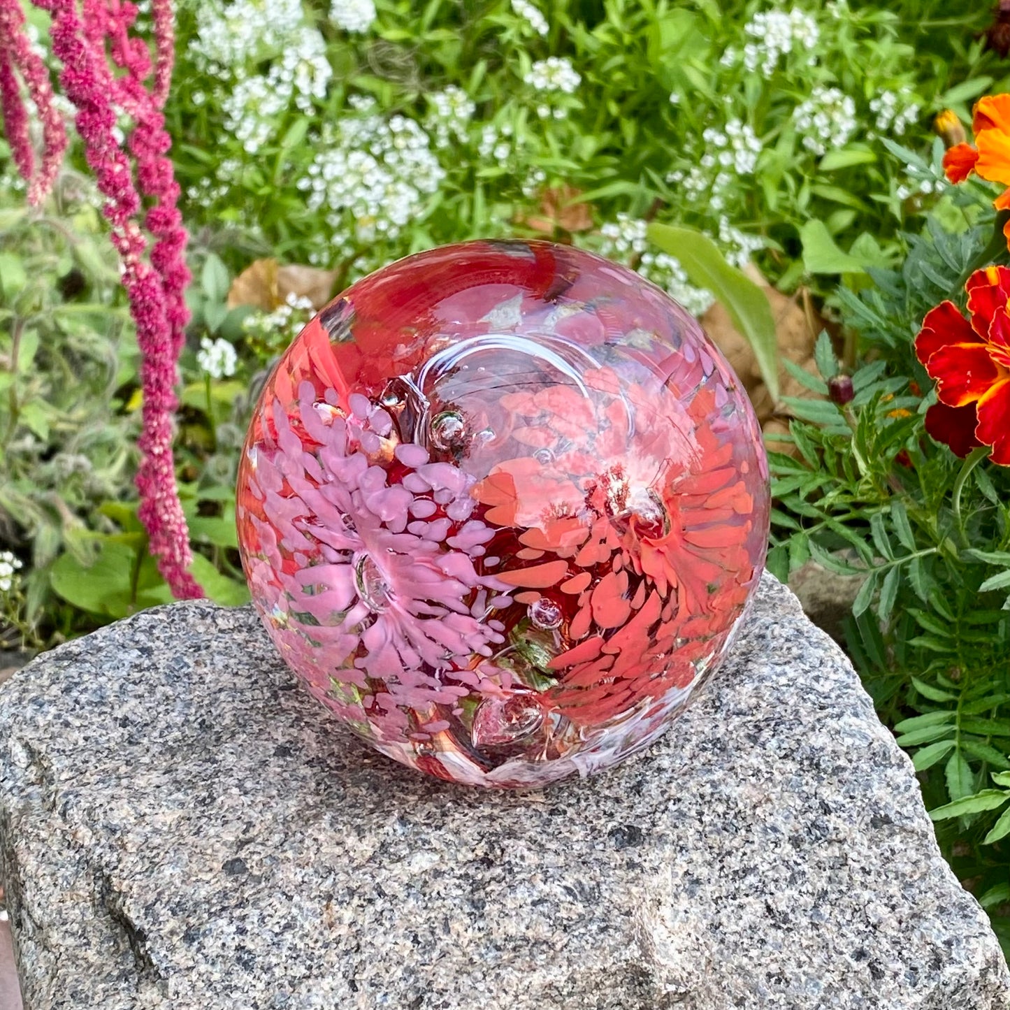 Eternal Garden glass keepsake with colorful floral pattern and visible swirling core in pink and red