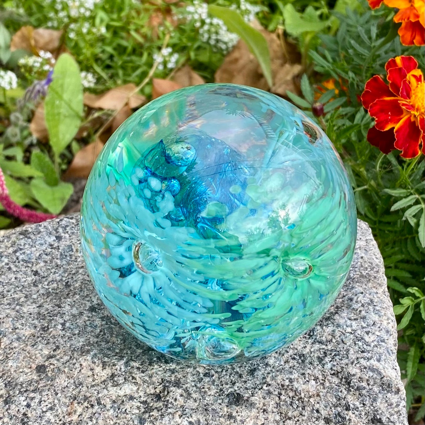 Handblown glass orb with colorful flower patterns and swirling memory core Aqua and blue 