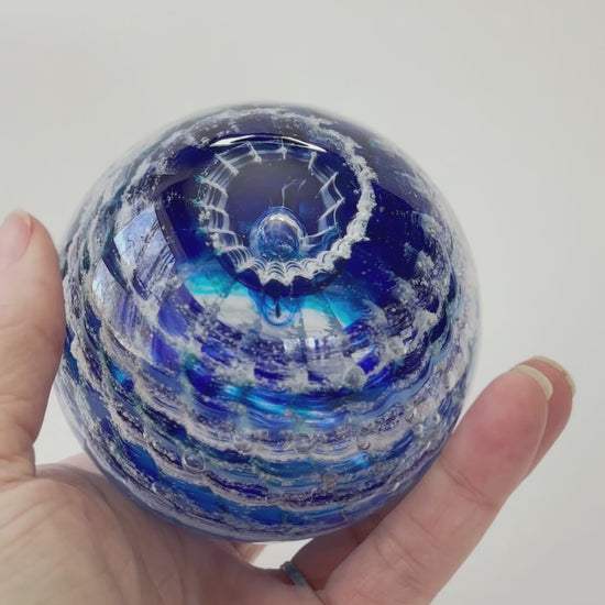 Handcrafted cremation keepsake with swirling ashes and layered transparent and opaque colors