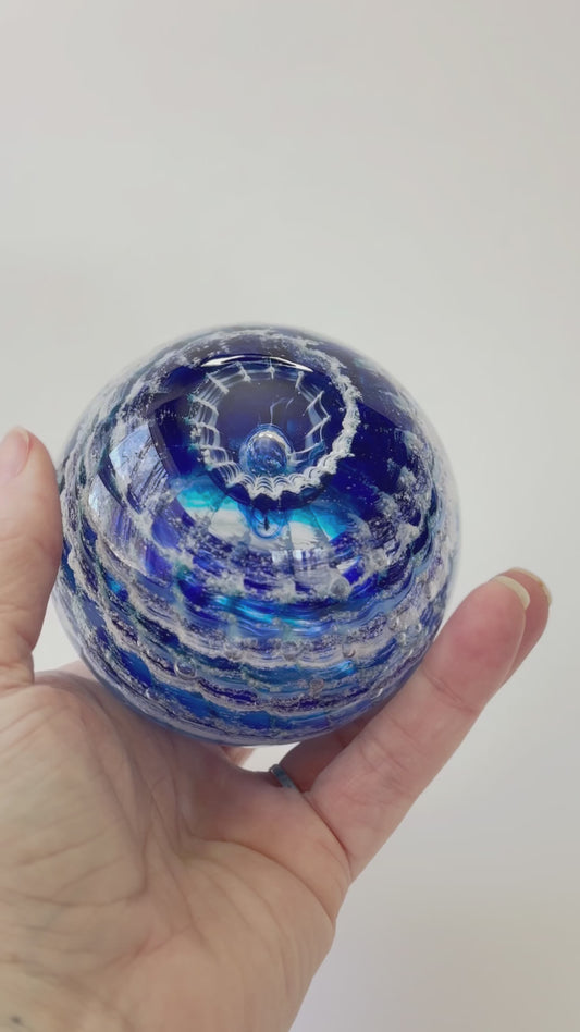 Handcrafted cremation keepsake with swirling ashes and layered transparent and opaque colors