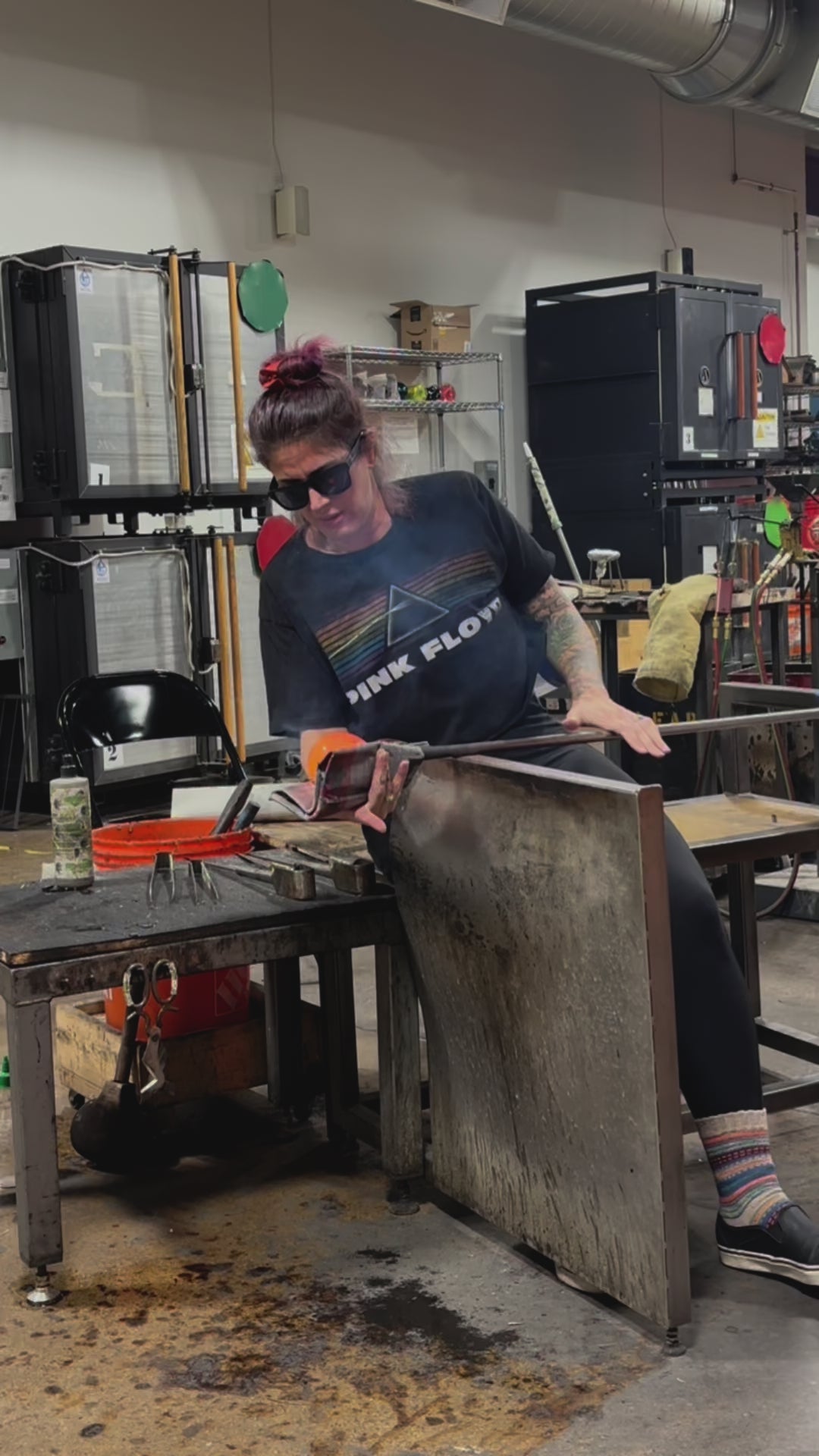 In the glass studio shaping molten glass and infused ashes. 